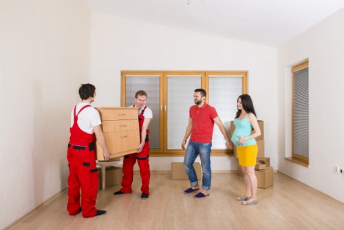 Professional movers handling office furniture