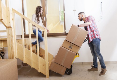 Small van load being carried down a stairwell in a Victorian terrace