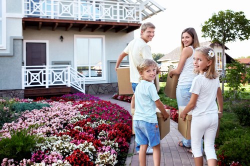 Workers using trolleys and PPE during a junk removal
